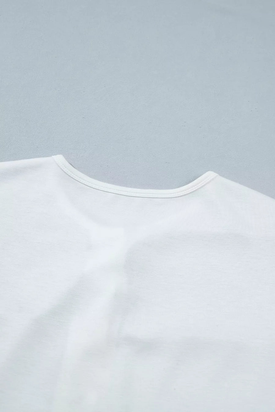 White polyester maternity t-shirt with a round neckline and short sleeves.