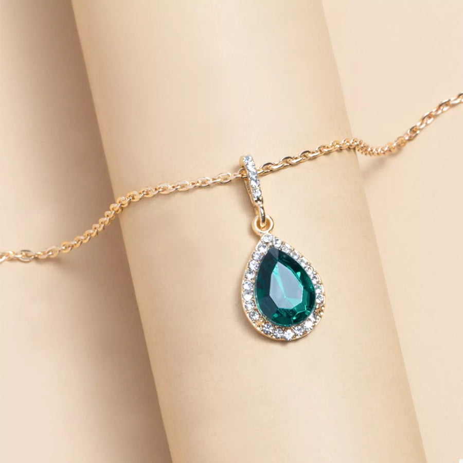 18K gold-plated necklace with a dark green teardrop crystal pendant surrounded by clear crystals.