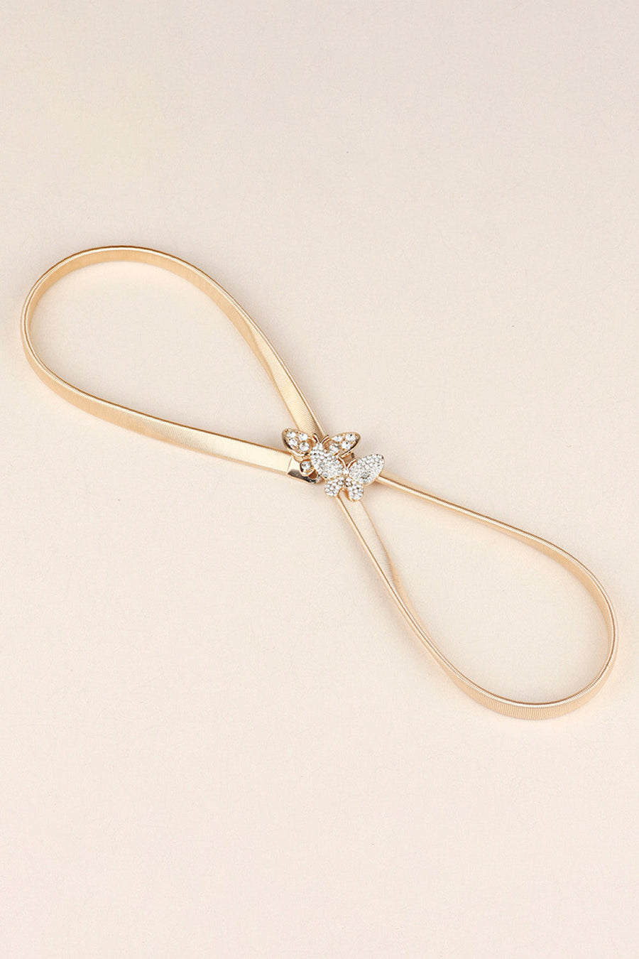 Gold metal belt with a crystal butterfly clasp detail