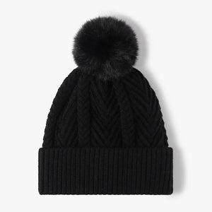 Black chevron knit beanie with a fluffy pom and ribbed cuff.