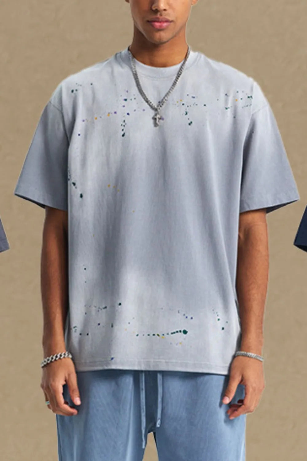 Gray oversized t-shirt with multicolor paint splatter detail and crew neck.