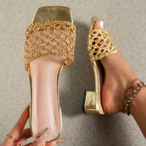 Gold woven mid-heel sandals with square toe and block heel.