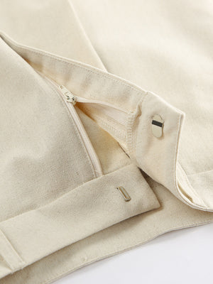 Buttoned vest and shorts set in natural cotton with zipper and button closure details.