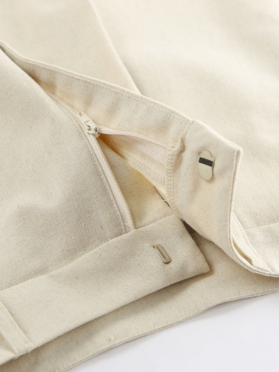 Buttoned vest and shorts set in natural cotton with zipper and button closure details.