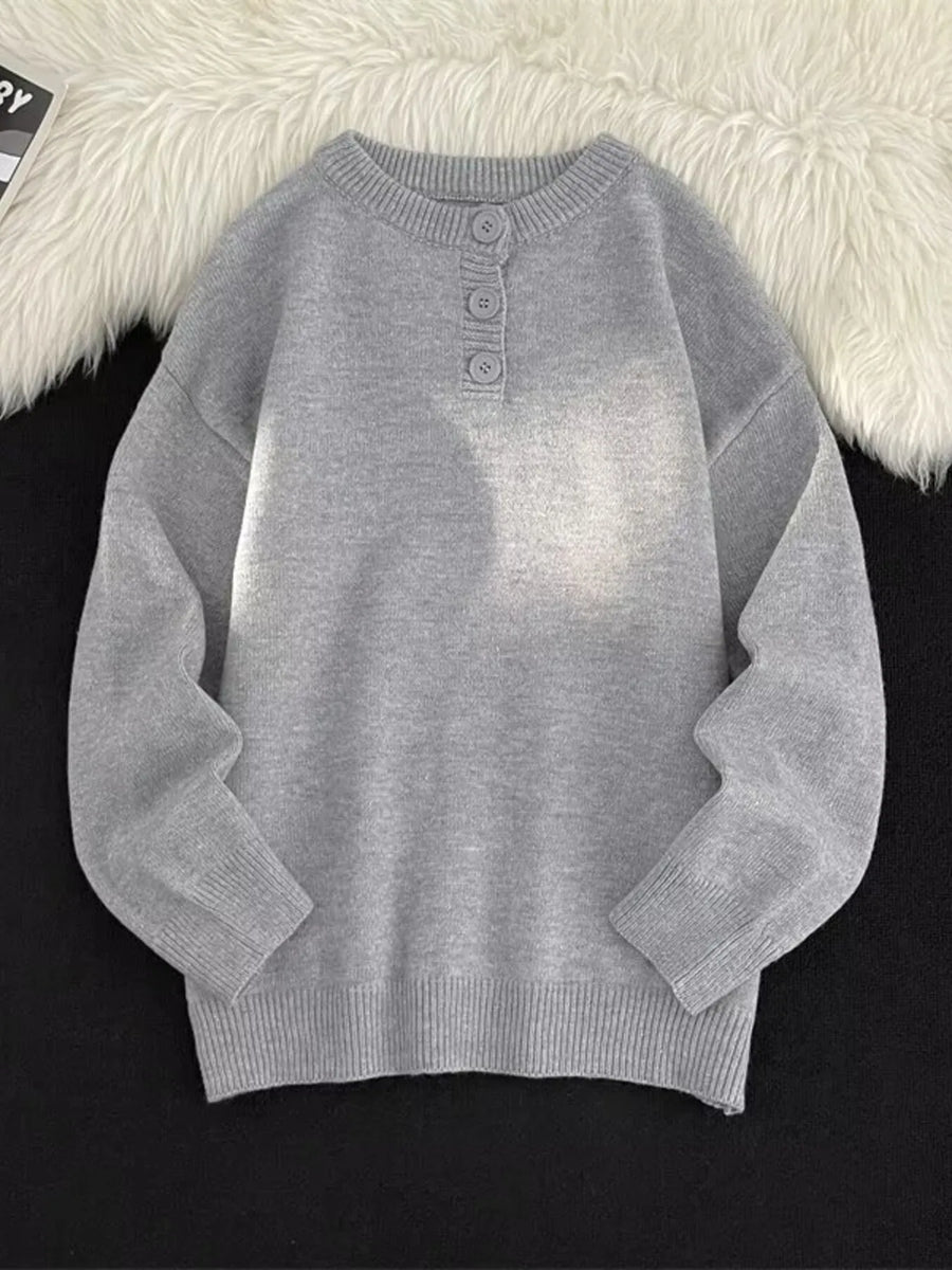 Light gray ribbed knit sweater with button detail at the neckline.