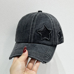 Black distressed baseball cap with embroidered stars and white stitching.