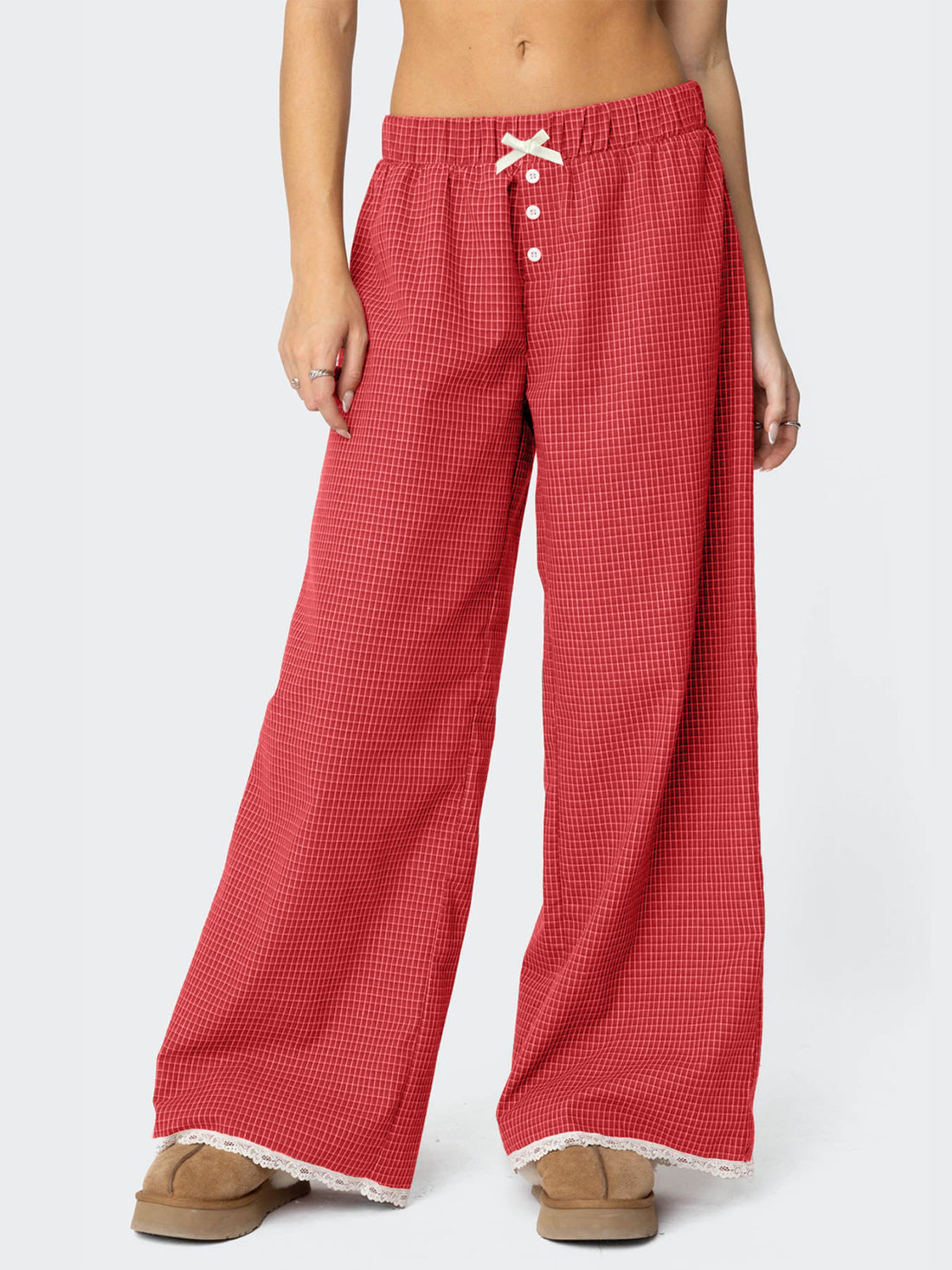 wide-leg pants in red featuring decorative button and flared fit