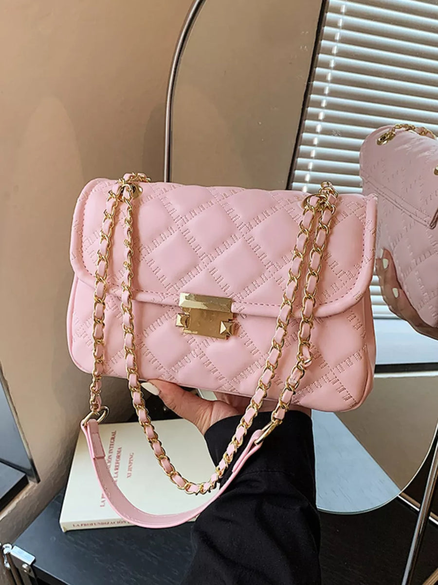 Pink crossbody bag featuring quilted and quilted