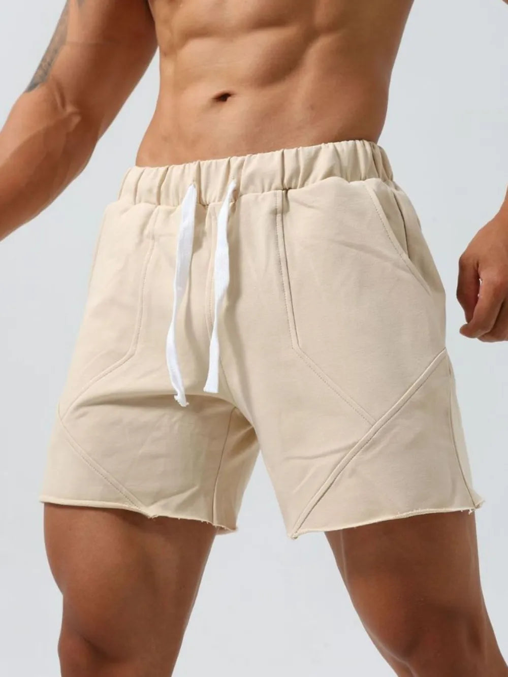 Khaki lounge shorts with raw-edge hem and seam details.