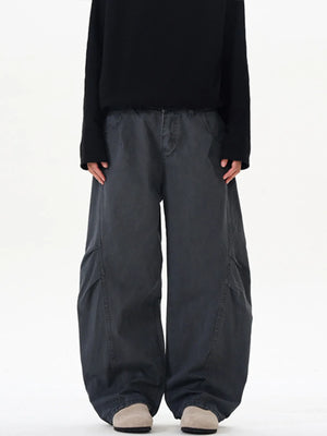 Men's oversized grey cargo pants with large side pockets and a relaxed fit.