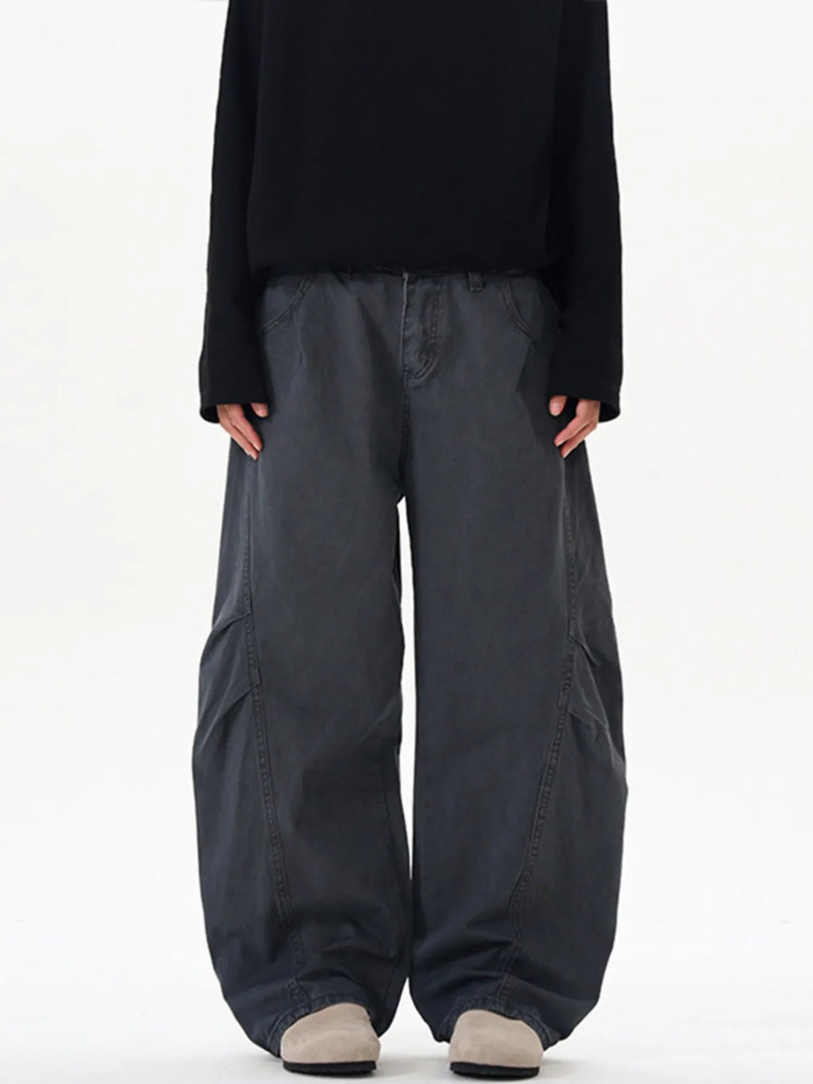 Men's oversized grey cargo pants with large side pockets and a relaxed fit.