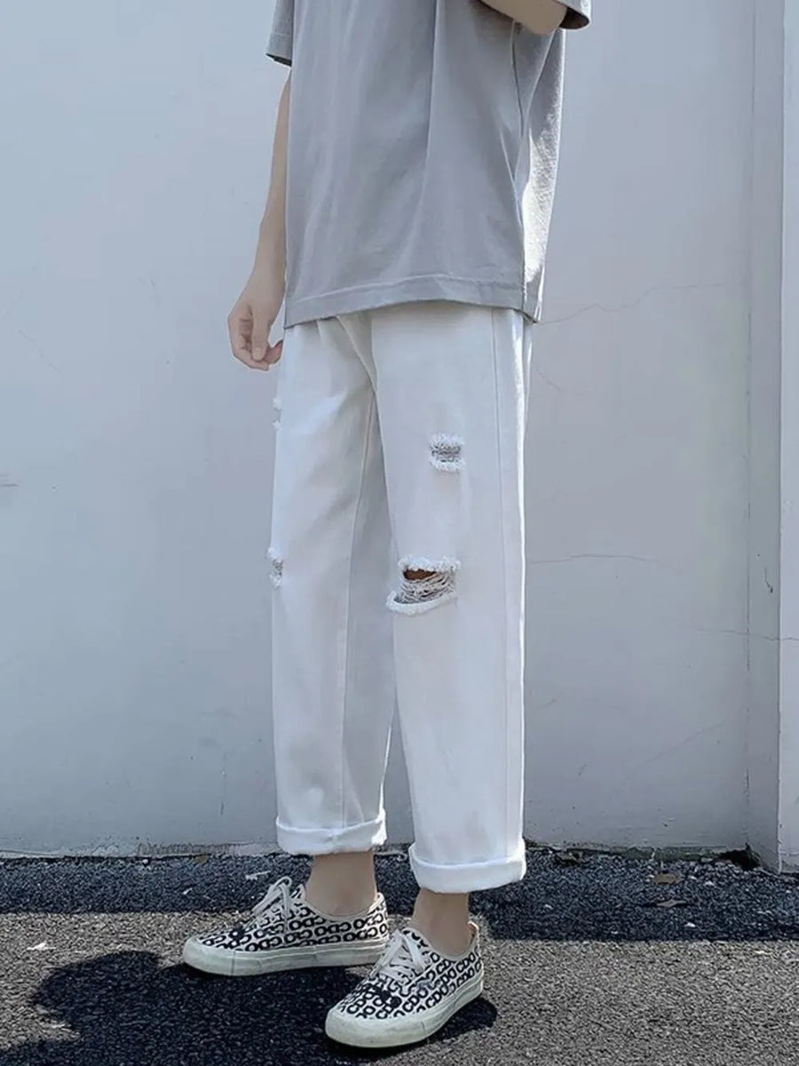 White distressed relaxed fit men's jeans with cuffed hem