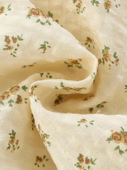 Cream cotton toddler dress with vintage floral print and puff sleeves.