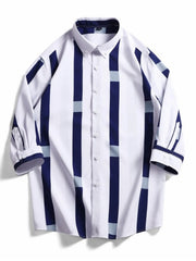 Oversized button-up shirt with white, navy, and light blue stripes.