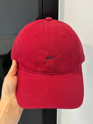 Red baseball cap with embroidered "plus" detail