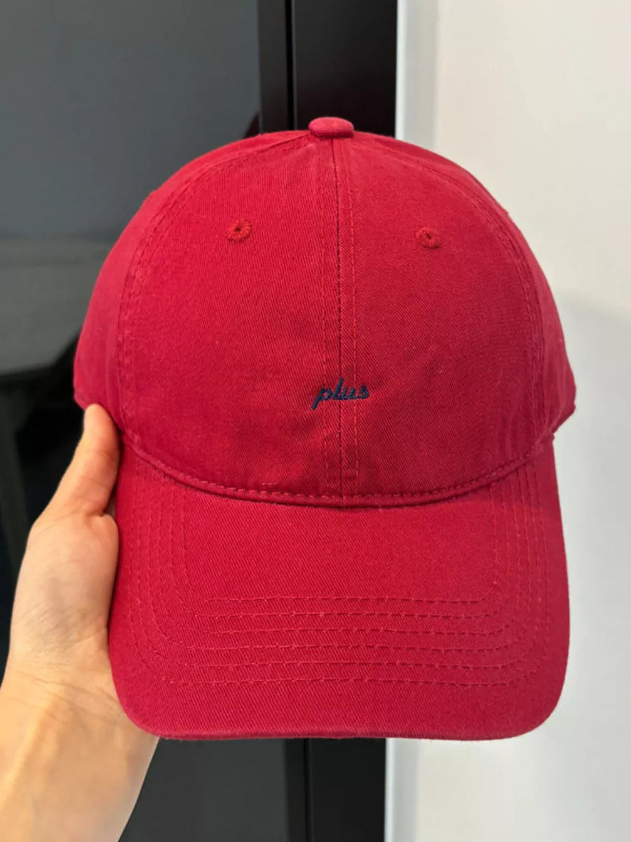 Red baseball cap with embroidered "plus" detail