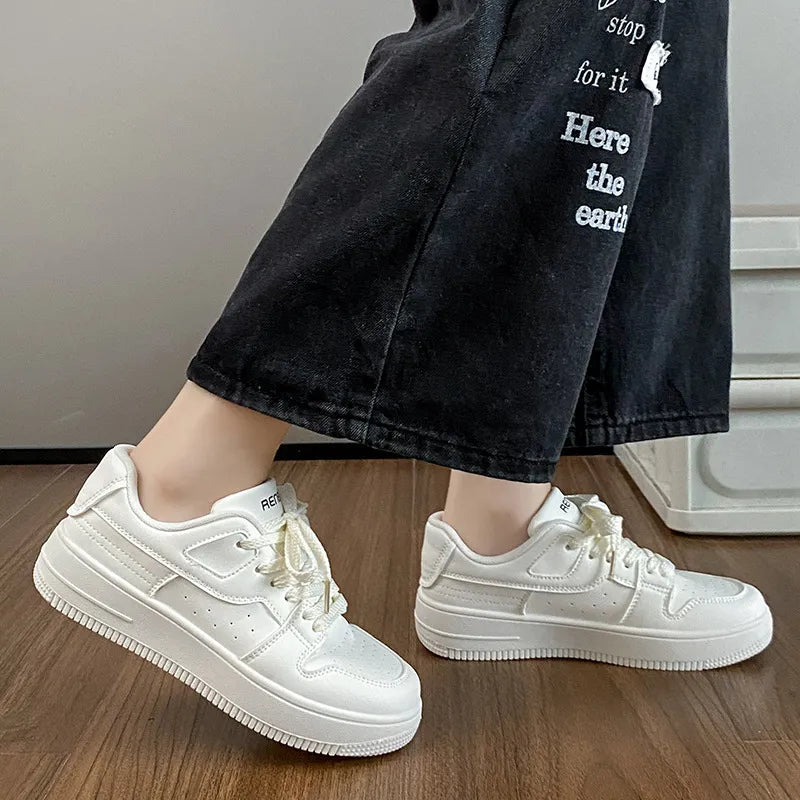 White leather sneakers with perforated details and a platform sole.