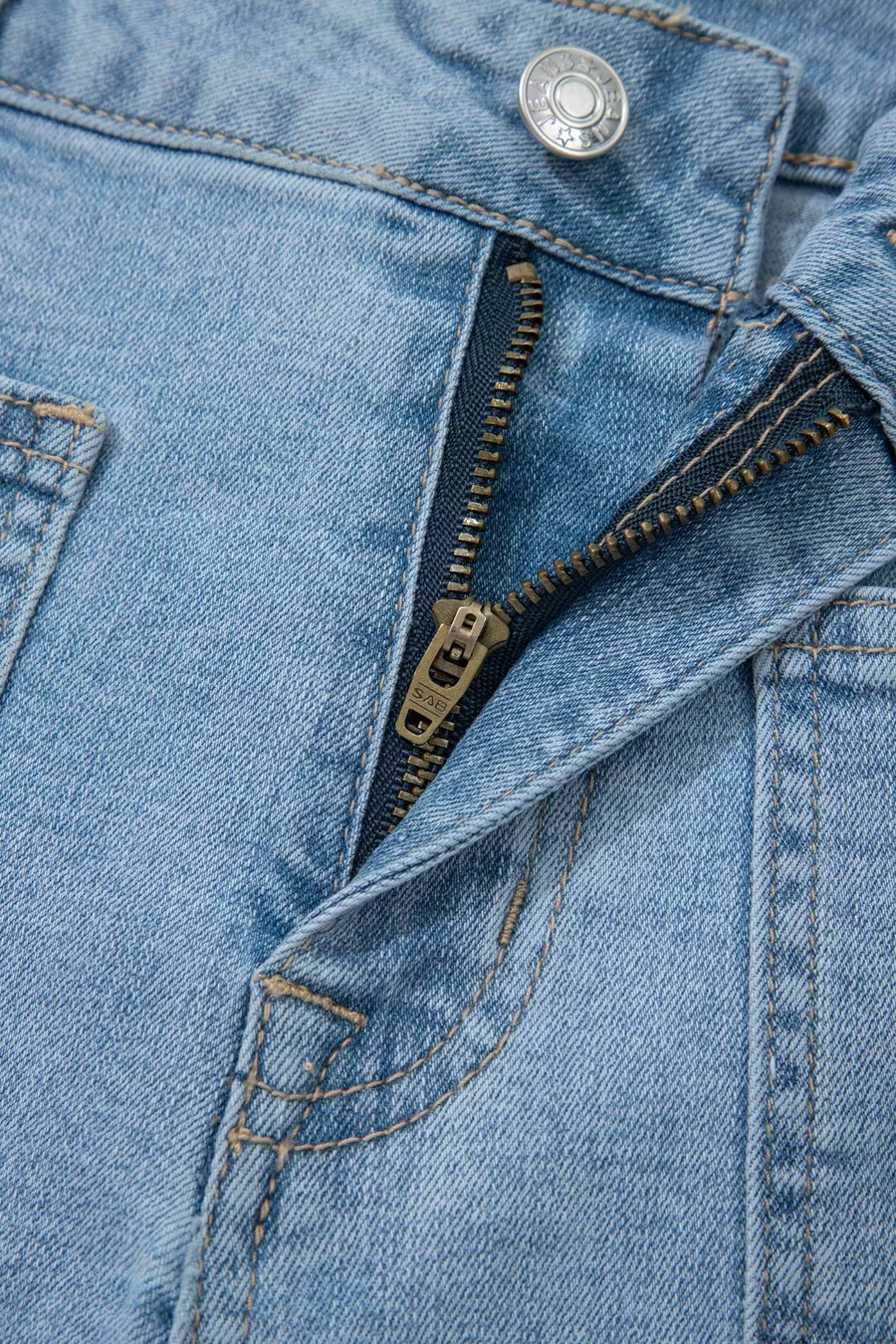 Light wash denim shorts with patch pockets and a zipper fly detail.