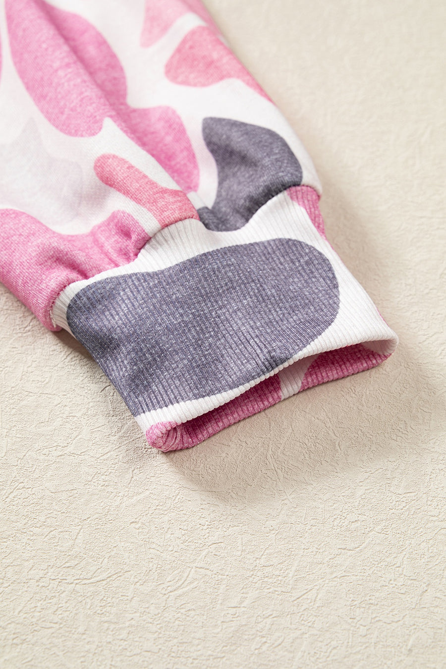 light pink sweatshirt with ribbed cuffs and long sleeve