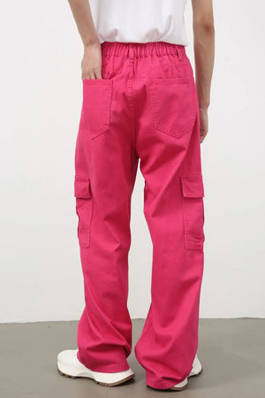 Electric pink baggy cargo pants with multiple pockets and a relaxed fit.