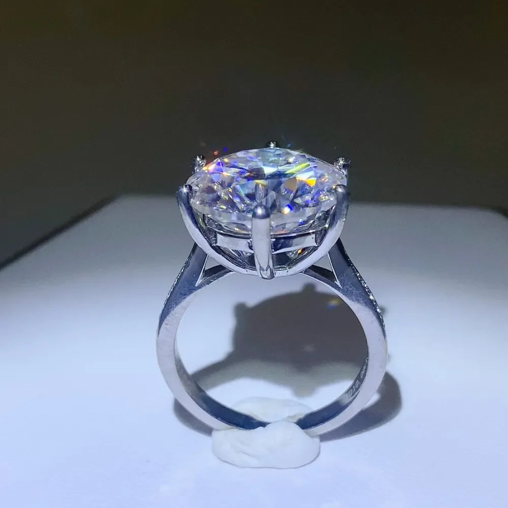 Silver engagement ring with large, sparkling round-cut diamond and pave band.
