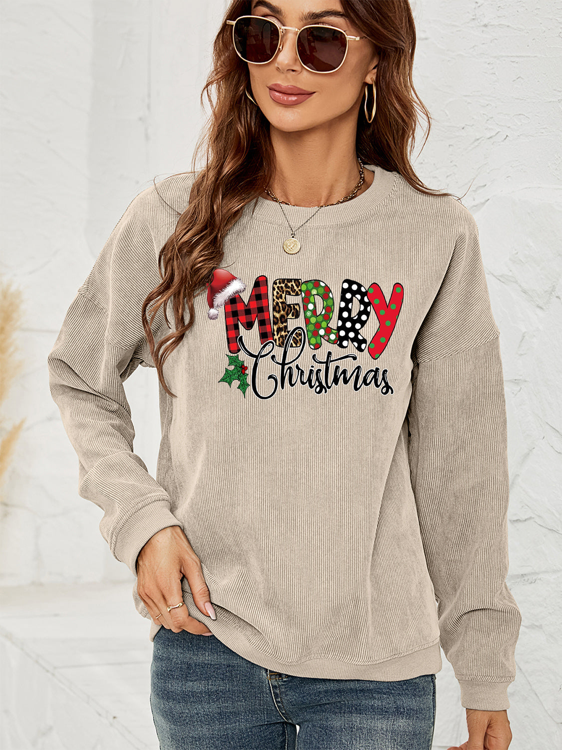 Beige corduroy sweatshirt with Merry Christmas graphic featuring Santa hat and plaid letters