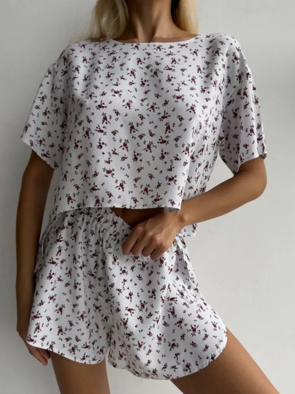 White floral print pajama set with relaxed short sleeve top and drawstring shorts.