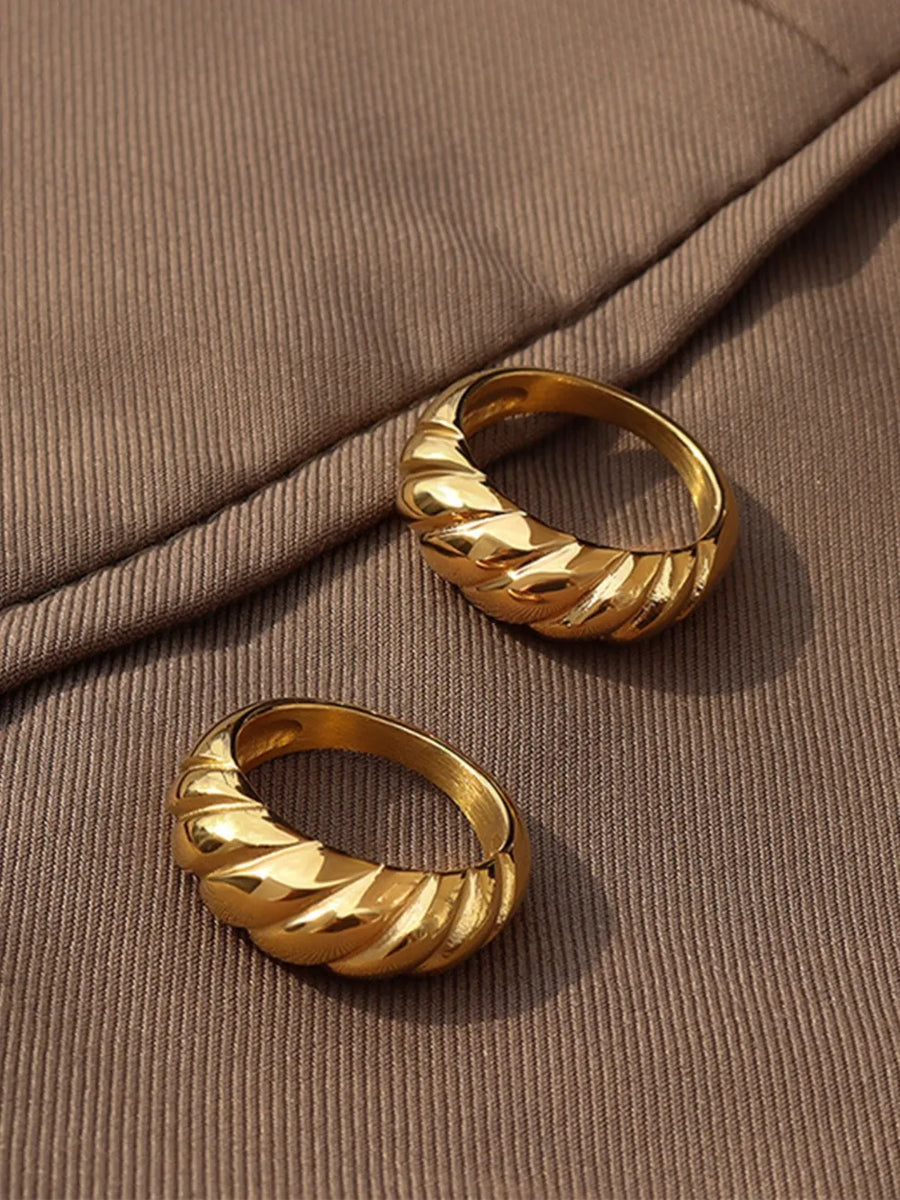 Gold sculpted steel croissant ring with twisted band detail