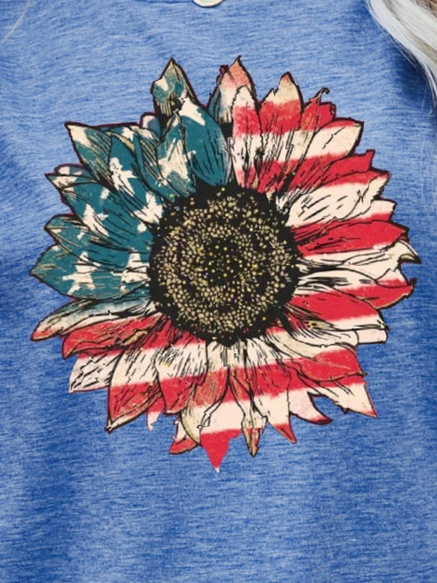 Cobalt blue graphic tee with a sunflower featuring Americana flag print petals.
