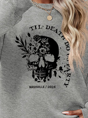 Gray raglan sweatshirt with floral skull graphic and text.