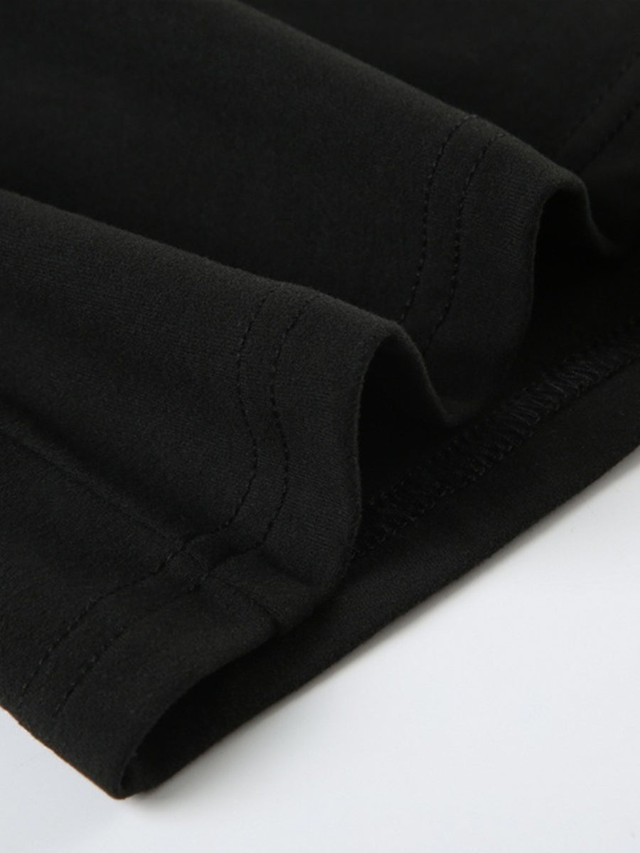 Black long-sleeve active romper with visible stitching detail