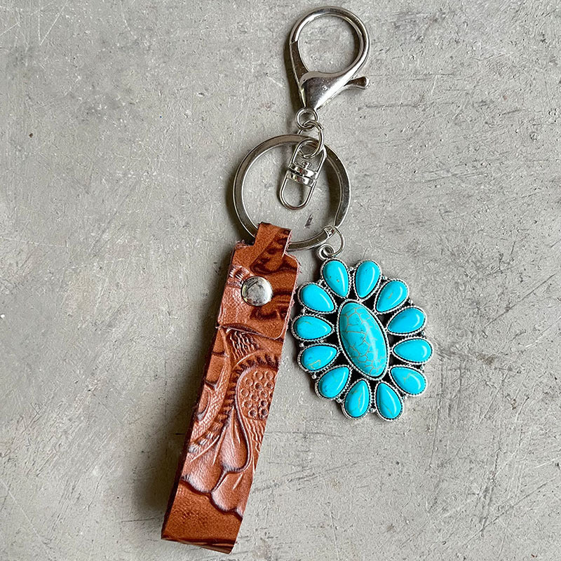 Tooled leather keychain with turquoise stone accent and alloy hardware.