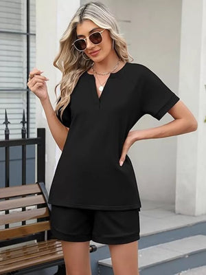 Black relaxed two-piece set with v-neck top and shorts.