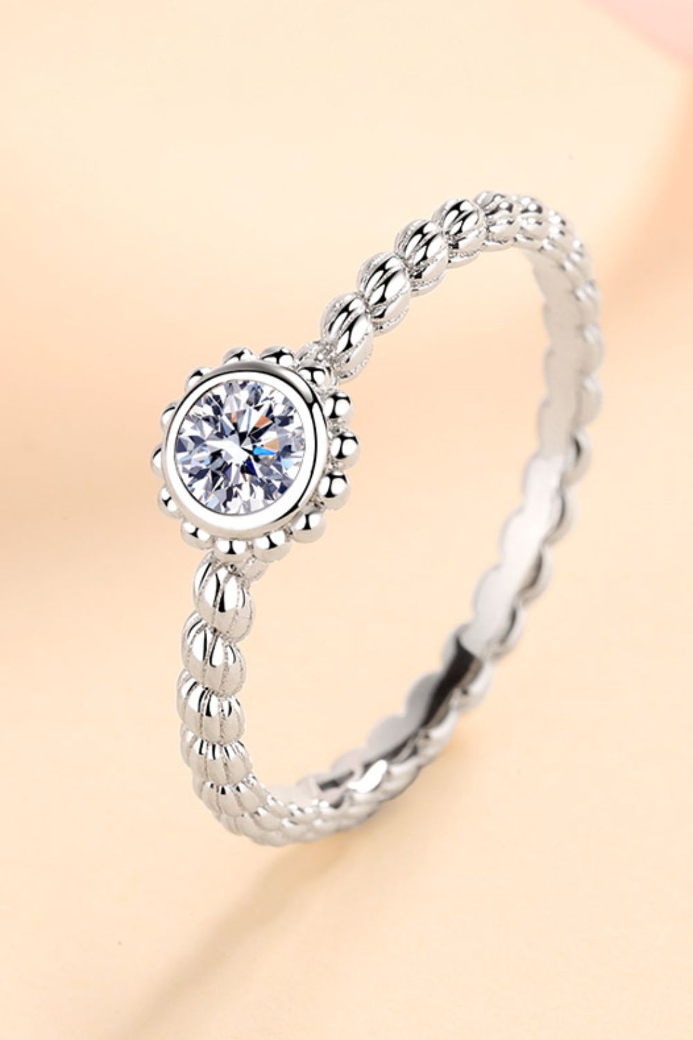 Silver beaded band ring with a 0.3 carat moissanite solitaire stone.