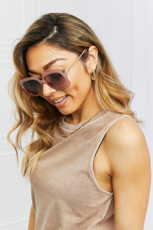 Sculpted square frame sunglasses in a soft pink hue with gold temples.
