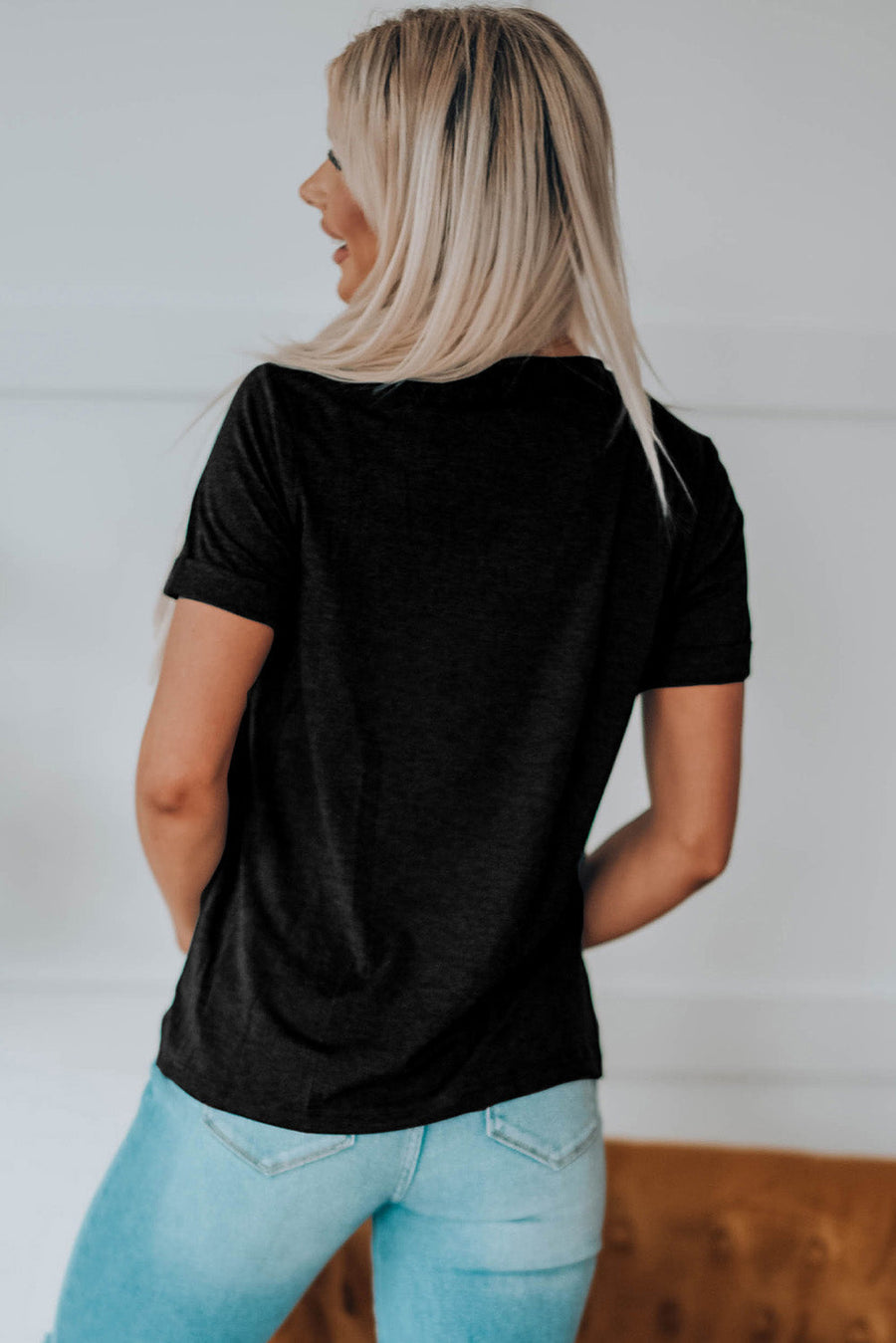 Black t-shirt with short sleeves and a crew neck, featuring a graphic print on the back.