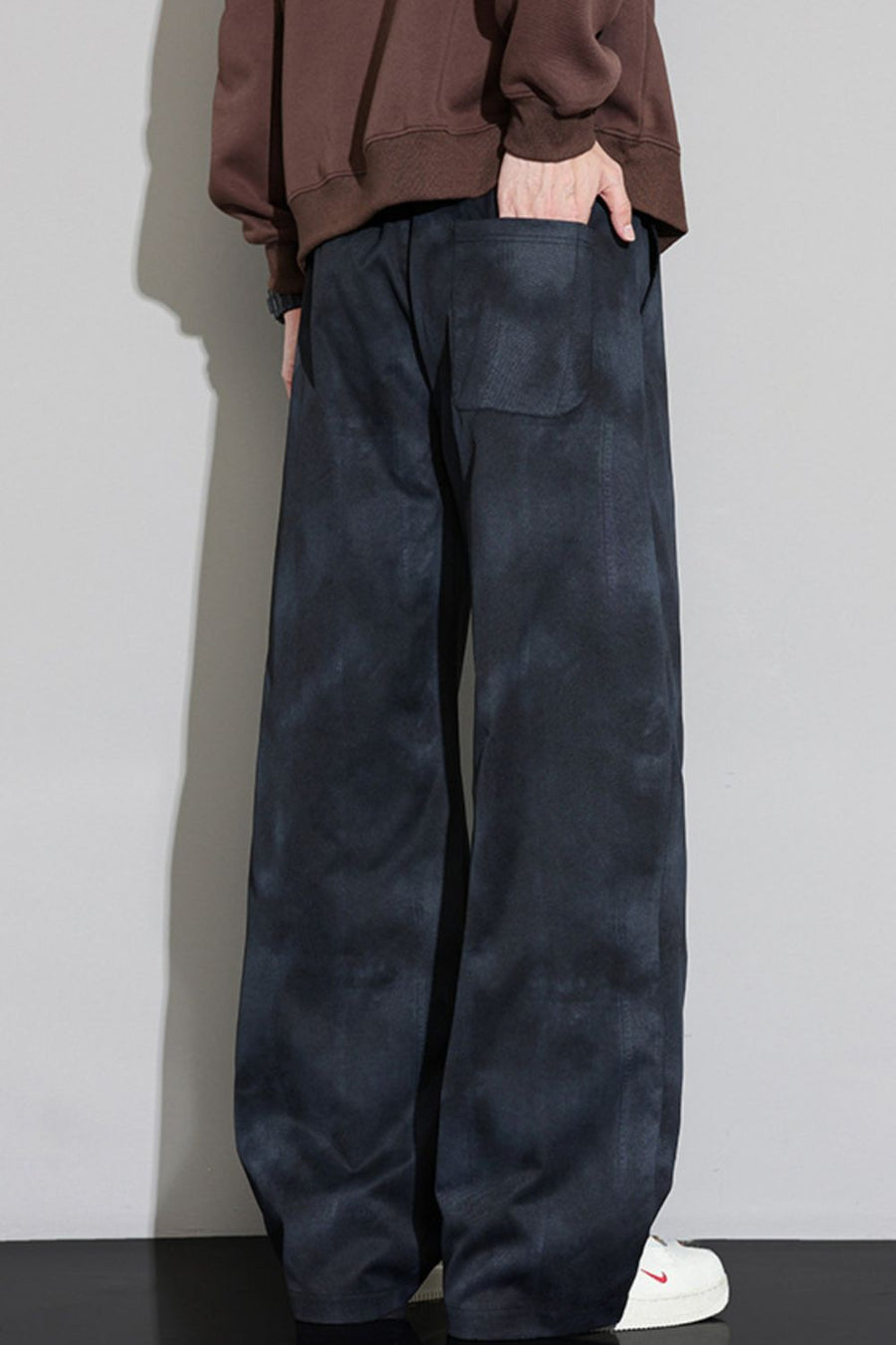 Black relaxed fit sweatpants with cloud pattern and pockets.