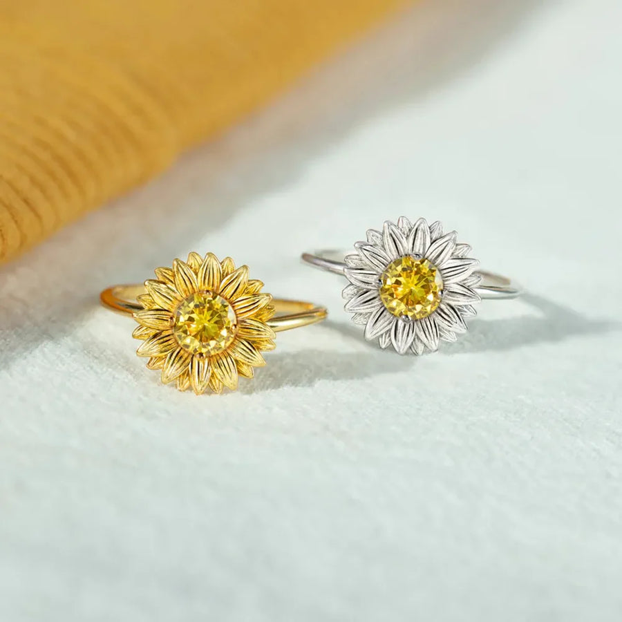 Gold and silver sunflower rings with yellow gemstone centers.