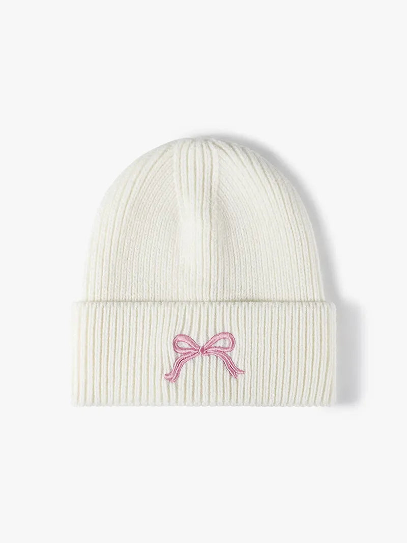 White ribbed knit beanie with embroidered pink bow detail