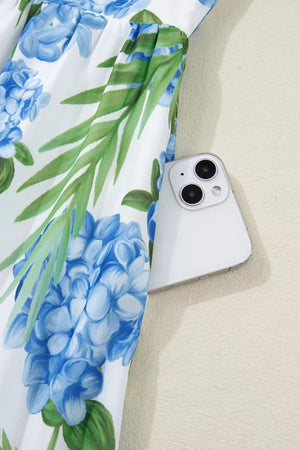 Ruffled mini dress with hydrangea and palm print, featuring a white background and blue floral pattern.
