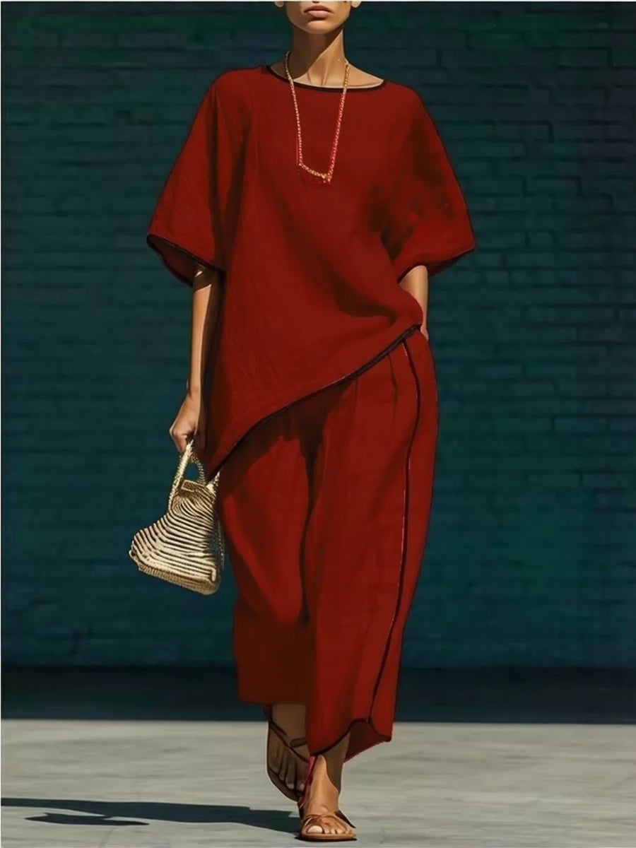 Burgundy two-piece set with contrast trim, cropped pants and asymmetrical top.