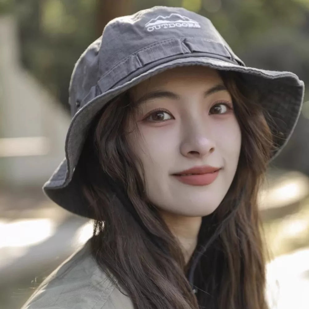 Bucket hat in gray cotton with embroidered outdoor logo detail.