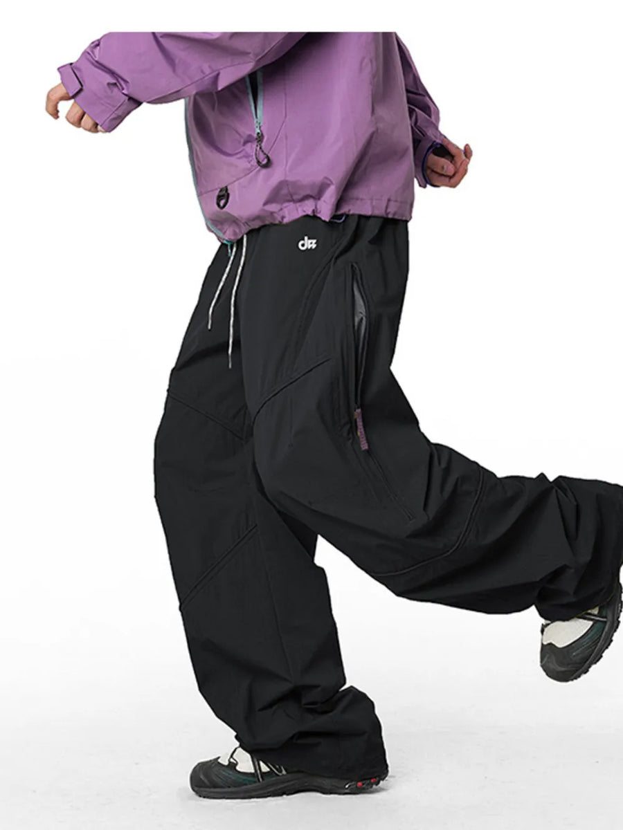 Relaxed fit black cargo active pants with drawstring and zippered pockets.