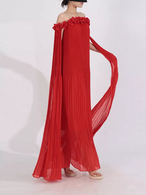 Red off-shoulder maxi dress with floral applique neckline and cape sleeves.