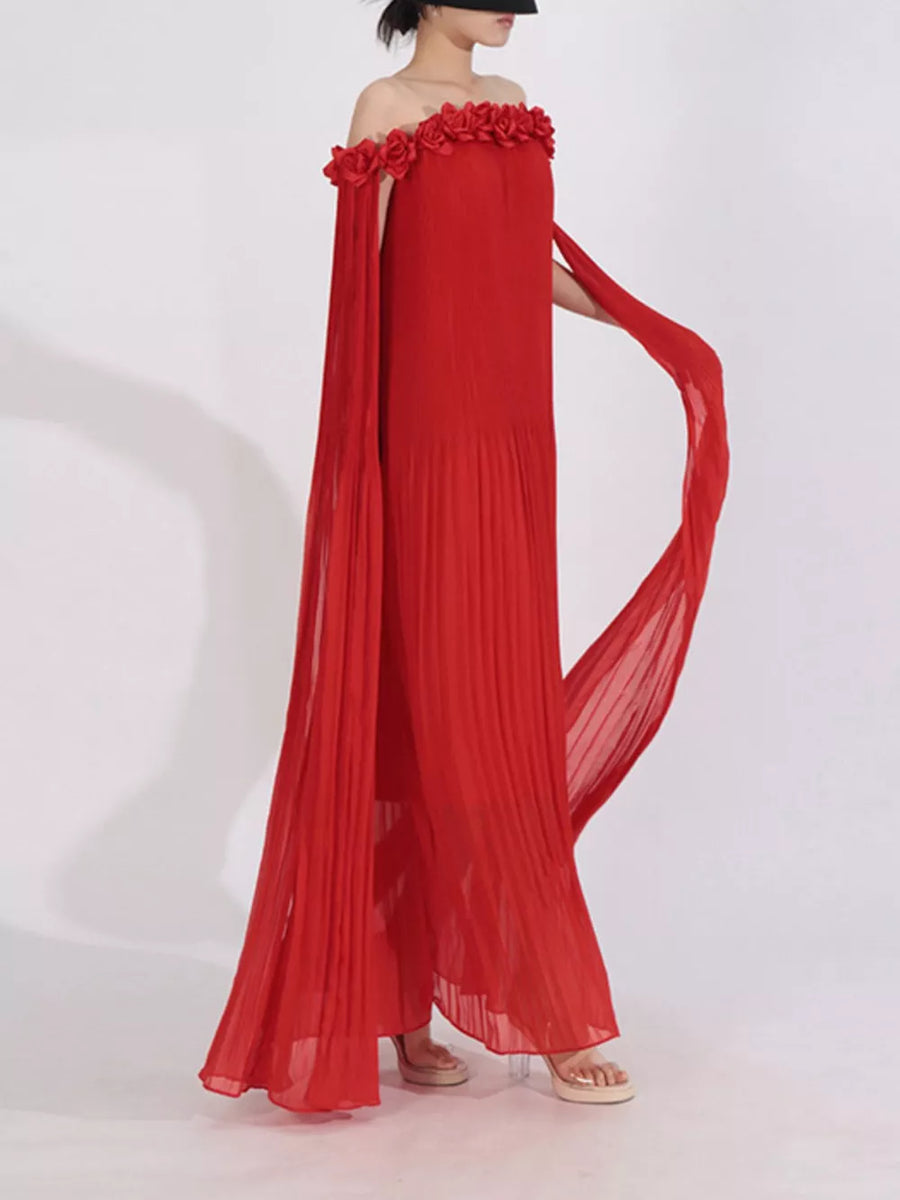 Red off-shoulder maxi dress with floral applique neckline and cape sleeves.