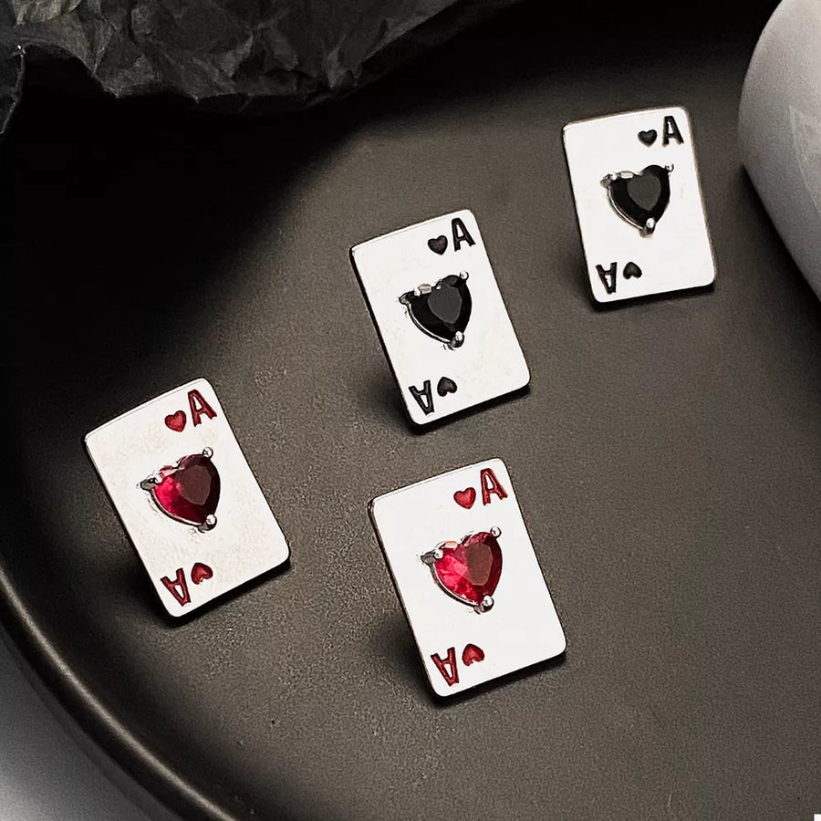 red earrings featuring rhinestone embellishment and playing card motif