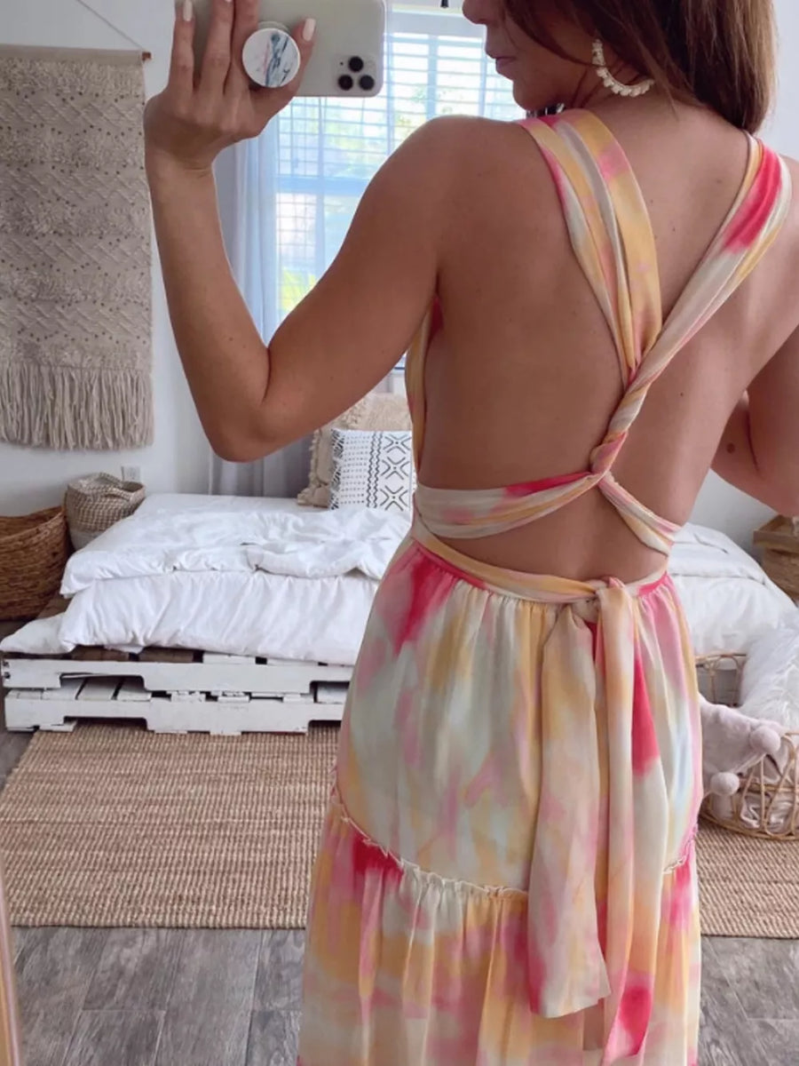 Vibrant tie-dye maxi dress with halter neckline and open back with tie detail.