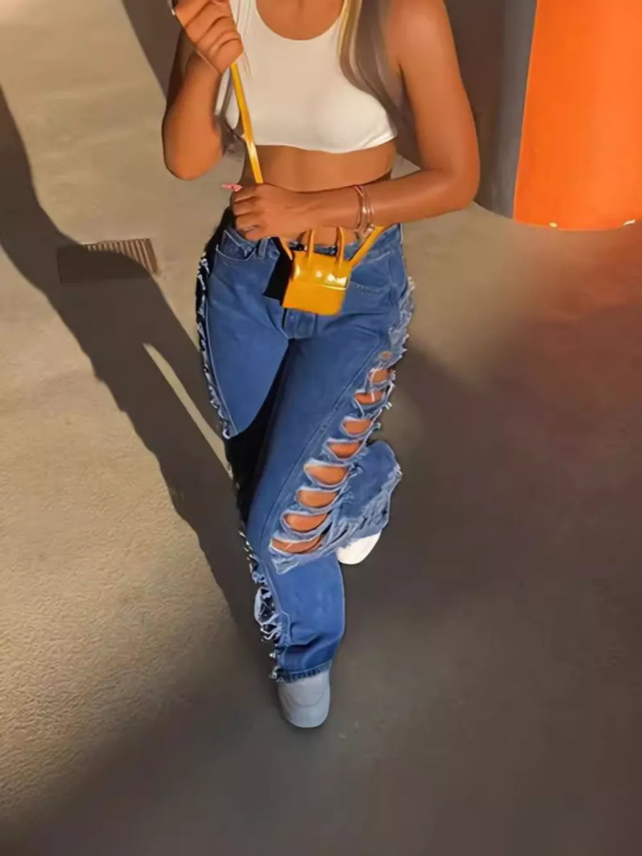Blue denim jeans with distressed side cutouts and lace-up detail.