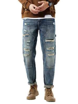 Men's distressed blue denim jeans with utility loop and patch details
