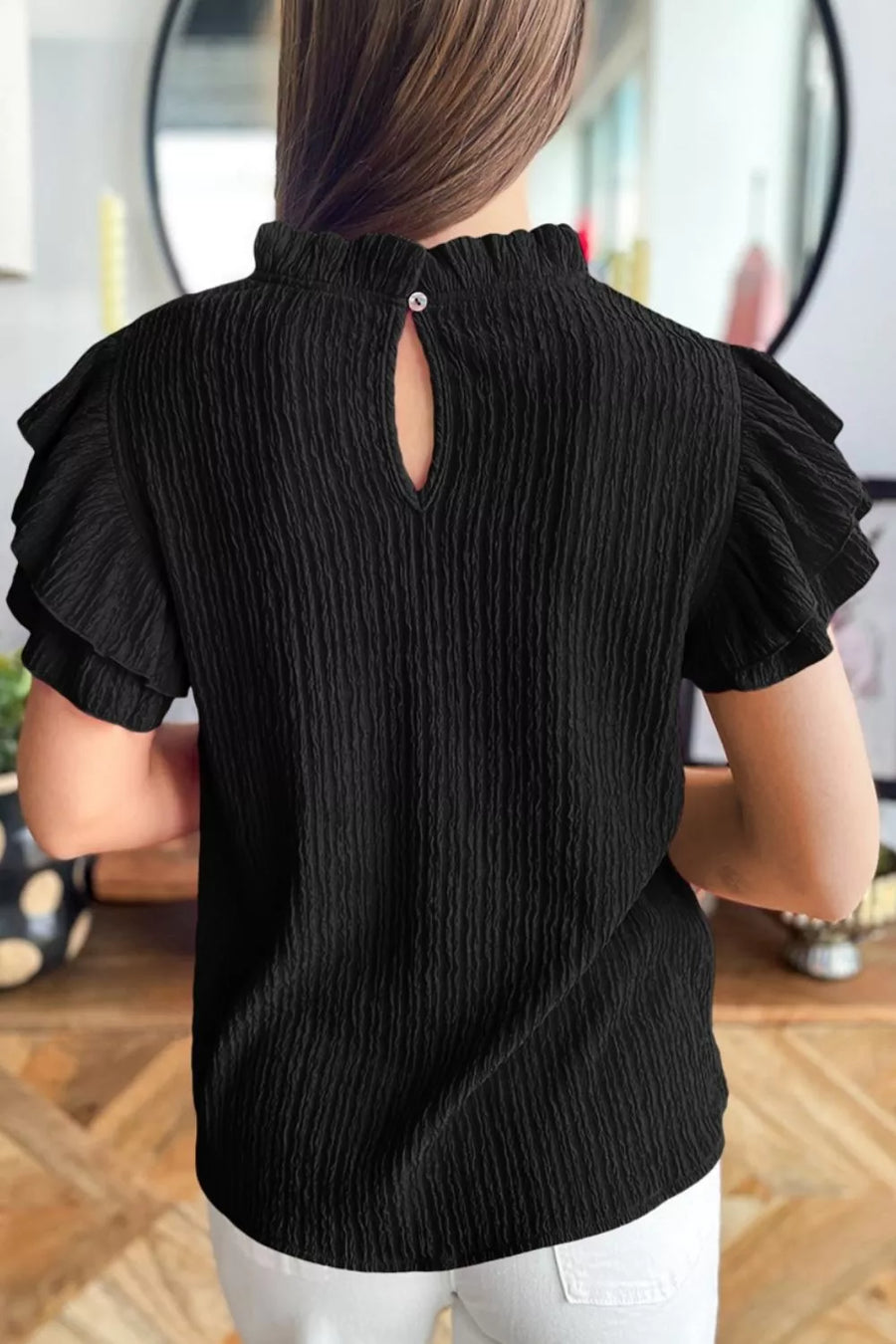 Black textured maternity shirt with frilled ruffle sleeves and mock neck with keyhole detail.
